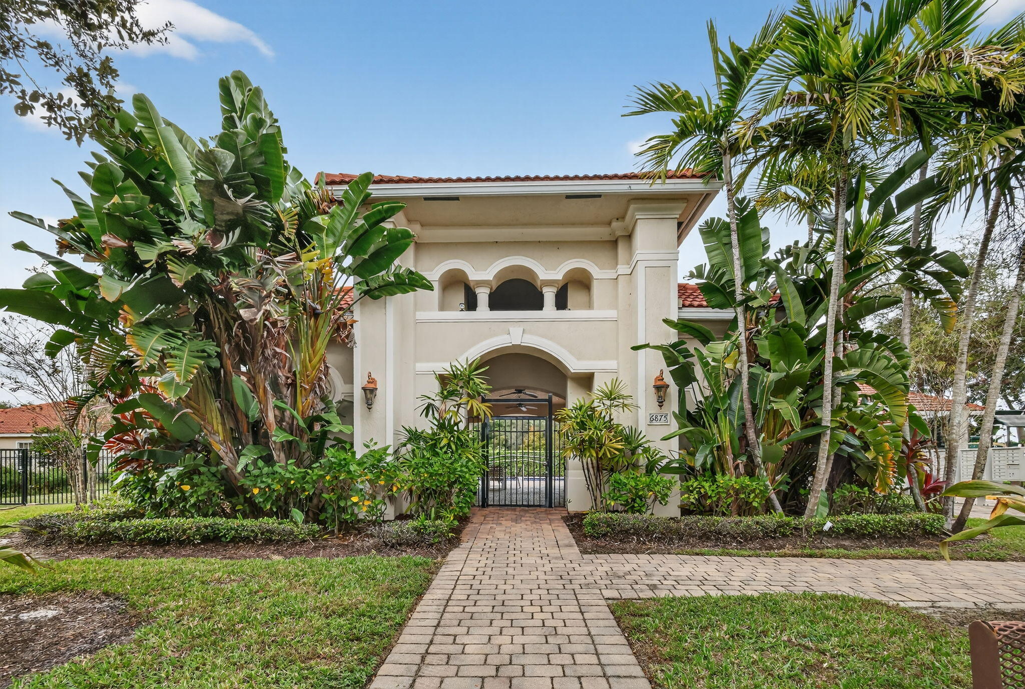 6720 Osage Circle Greenacres, FL 33413 - Photo 53 of 54 a front view of a house with a garden