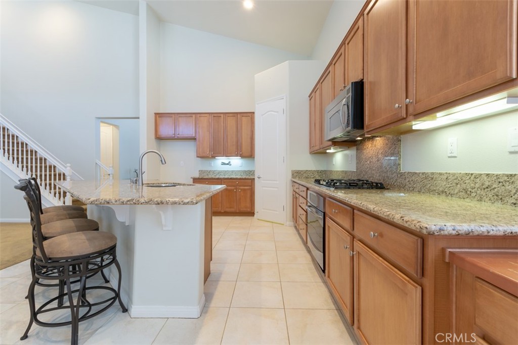 41640 Merryvale Lane Palmdale, CA 93551 - Photo 13 of 40 a kitchen with stainless steel appliances granite countertop a sink stove and cabinets