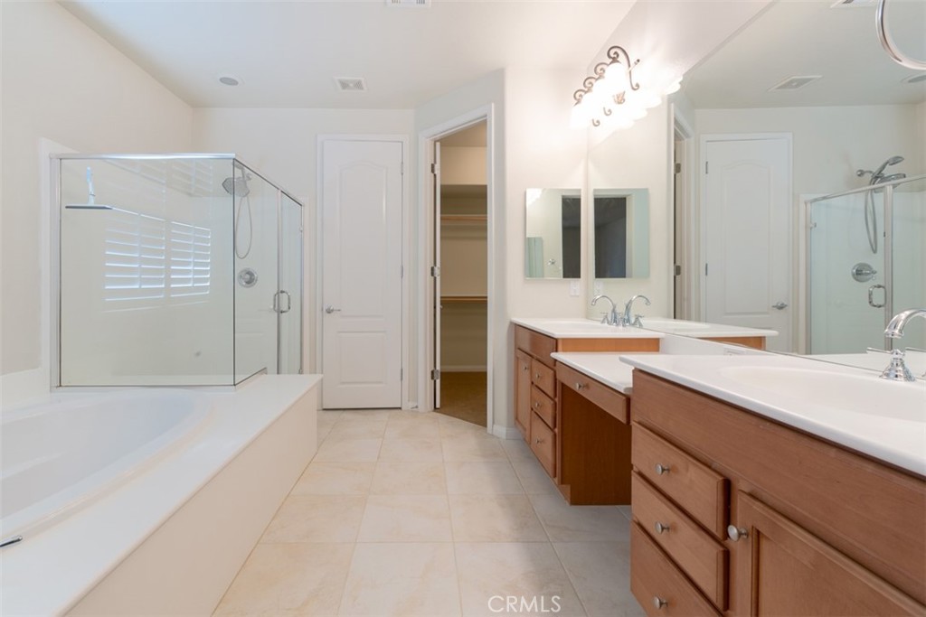 41640 Merryvale Lane Palmdale, CA 93551 - Photo 20 of 40 a spacious bathroom with a double vanity sink shower and a mirror