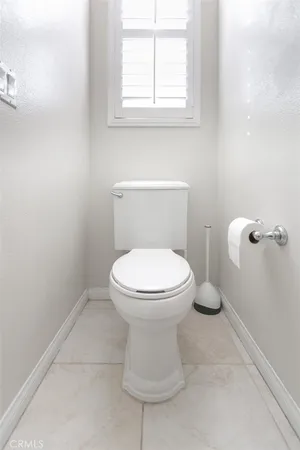 a bathroom with a double vanity sink toilet mirror and shower