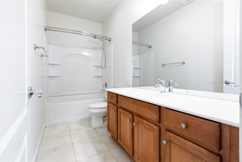 41640 Merryvale Lane Palmdale, CA 93551 - Photo 25 of 40 a bathroom with a double vanity sink toilet mirror and shower