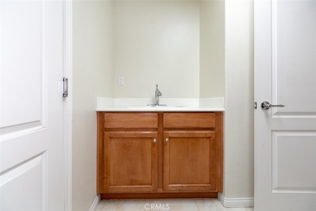 41640 Merryvale Lane Palmdale, CA 93551 - Photo 36 of 40 a bathroom with a granite countertop sink and vanity