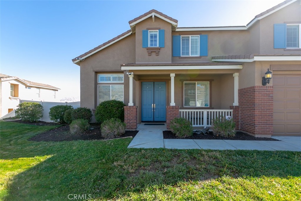 41640 Merryvale Lane Palmdale, CA 93551 - Photo 7 of 40 a view of a brick house with a yard plants and large windows