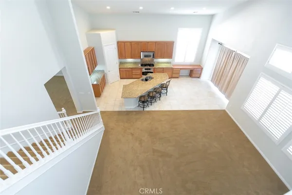 a dining room with furniture and a large window
