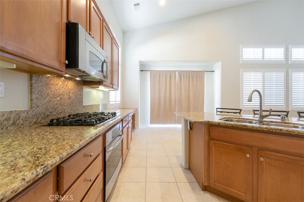 41640 Merryvale Lane Palmdale, CA 93551 - Photo 10 of 40 a kitchen with stainless steel appliances granite countertop a sink stove and cabinets