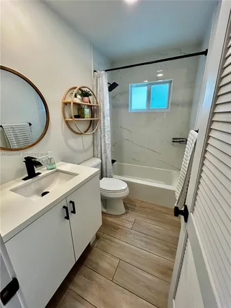 a bathroom with a double vanity sink mirror and toilet