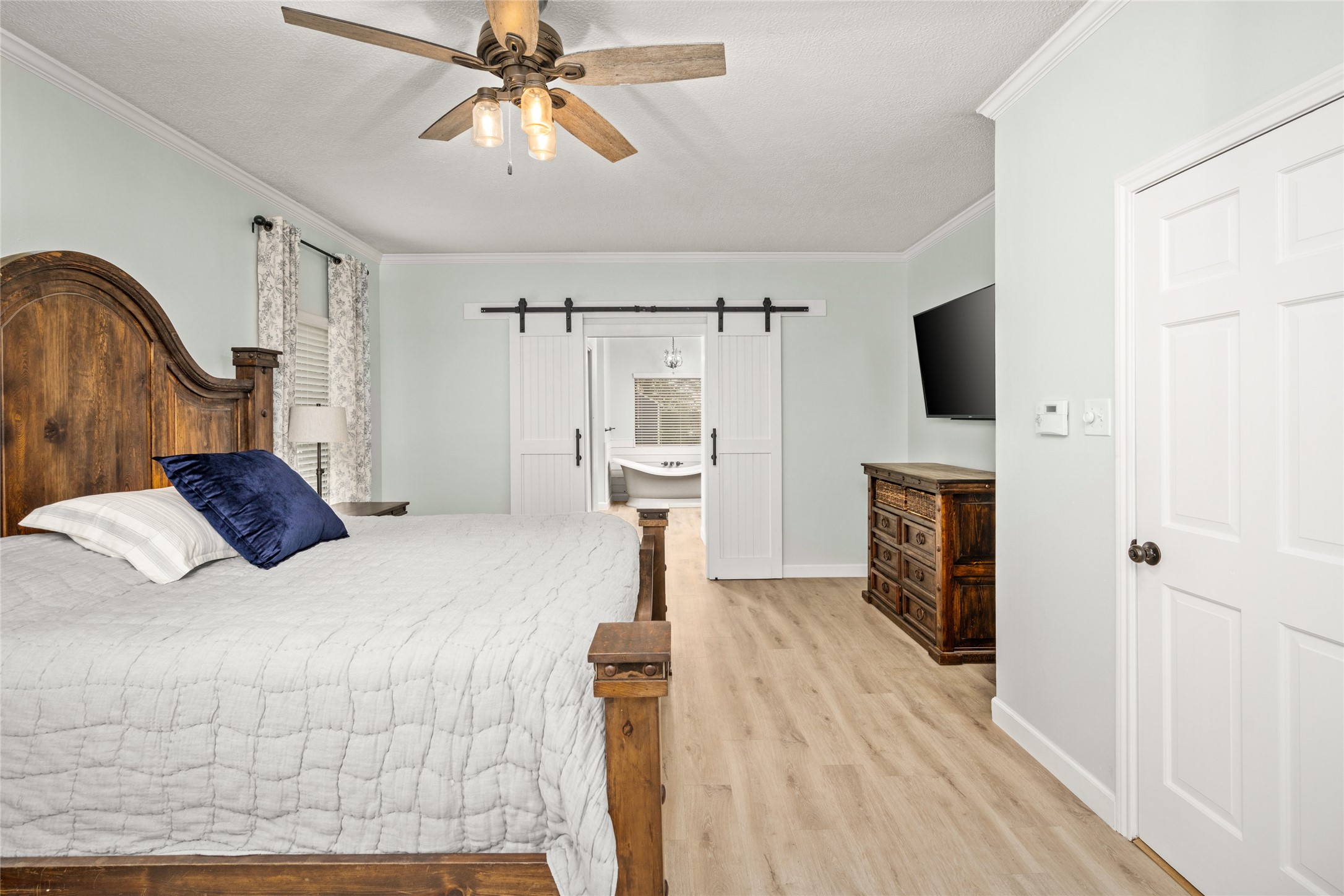77 South Placid Hill Circle Spring, TX 77381 - Photo 21 of 48 Secondary view of the primary with updated flooring and sliding barn door entry into the remodeled luxury bath.