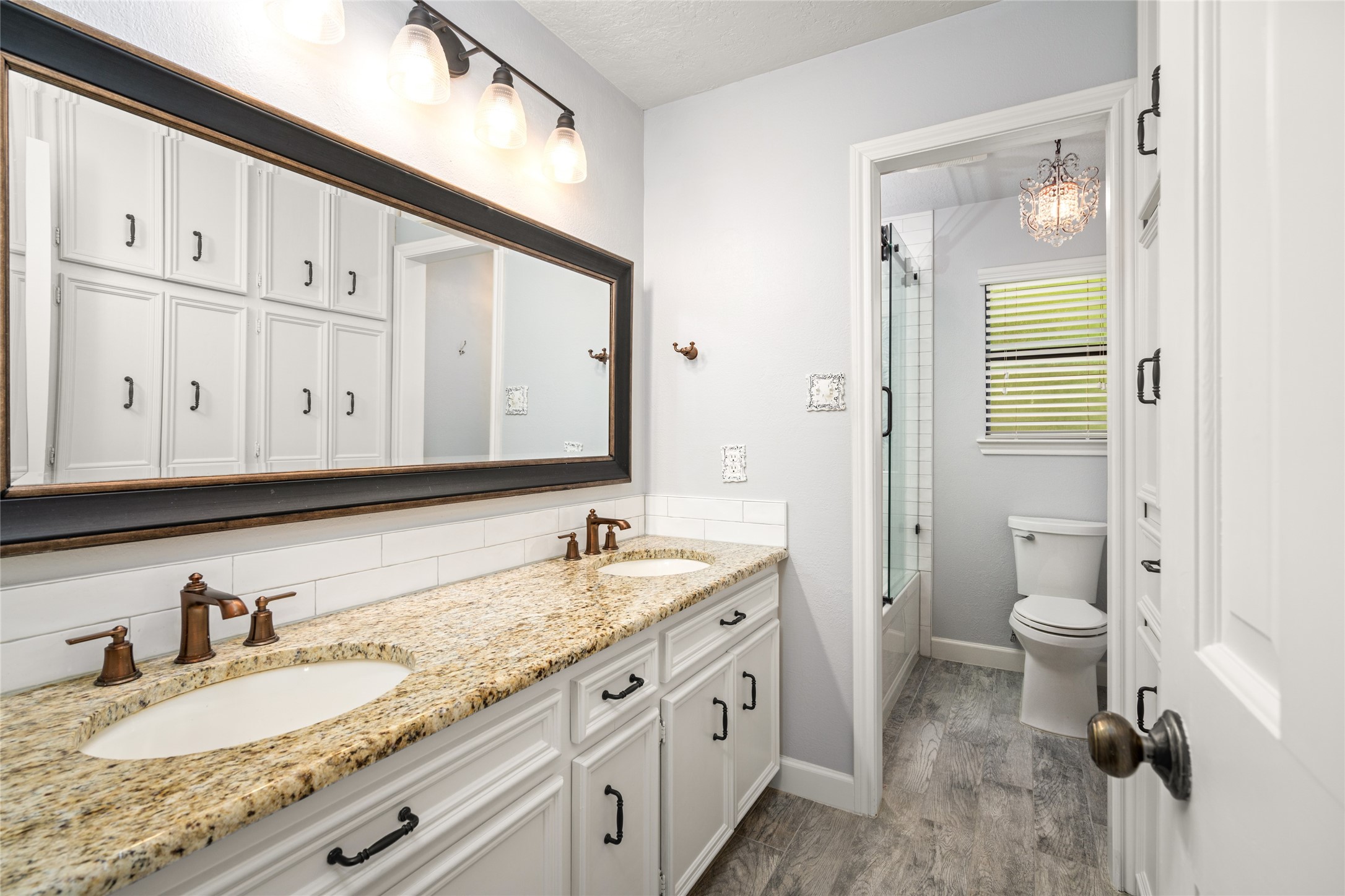 77 South Placid Hill Circle Spring, TX 77381 - Photo 30 of 48 Updated guest bathroom with dual sinks, granite countertops, custom fixtures, and modern finishes.