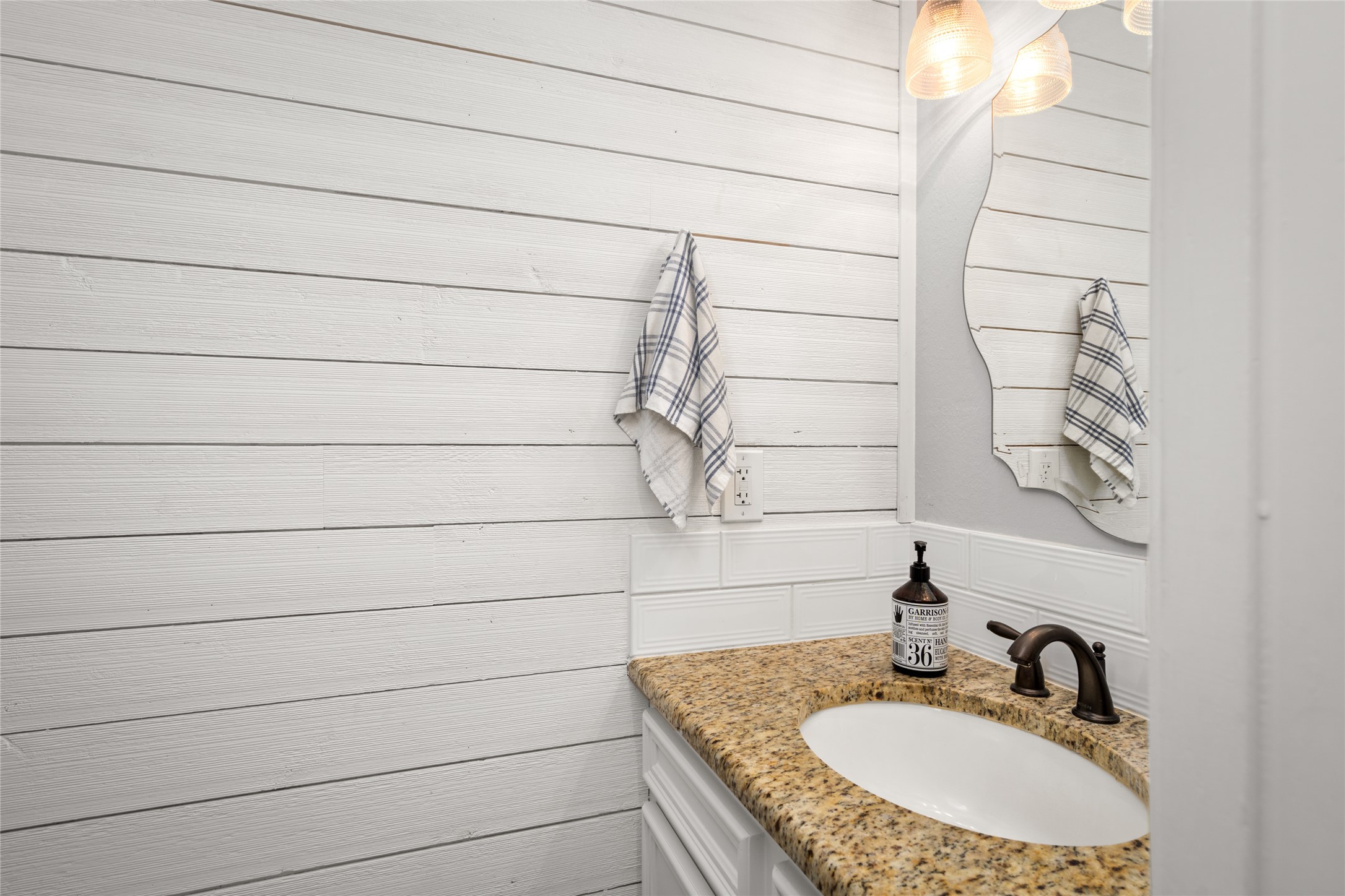 77 South Placid Hill Circle Spring, TX 77381 - Photo 34 of 48 Updated half bath off the laundry room with granite top, tile backsplash, and shiplap wall.