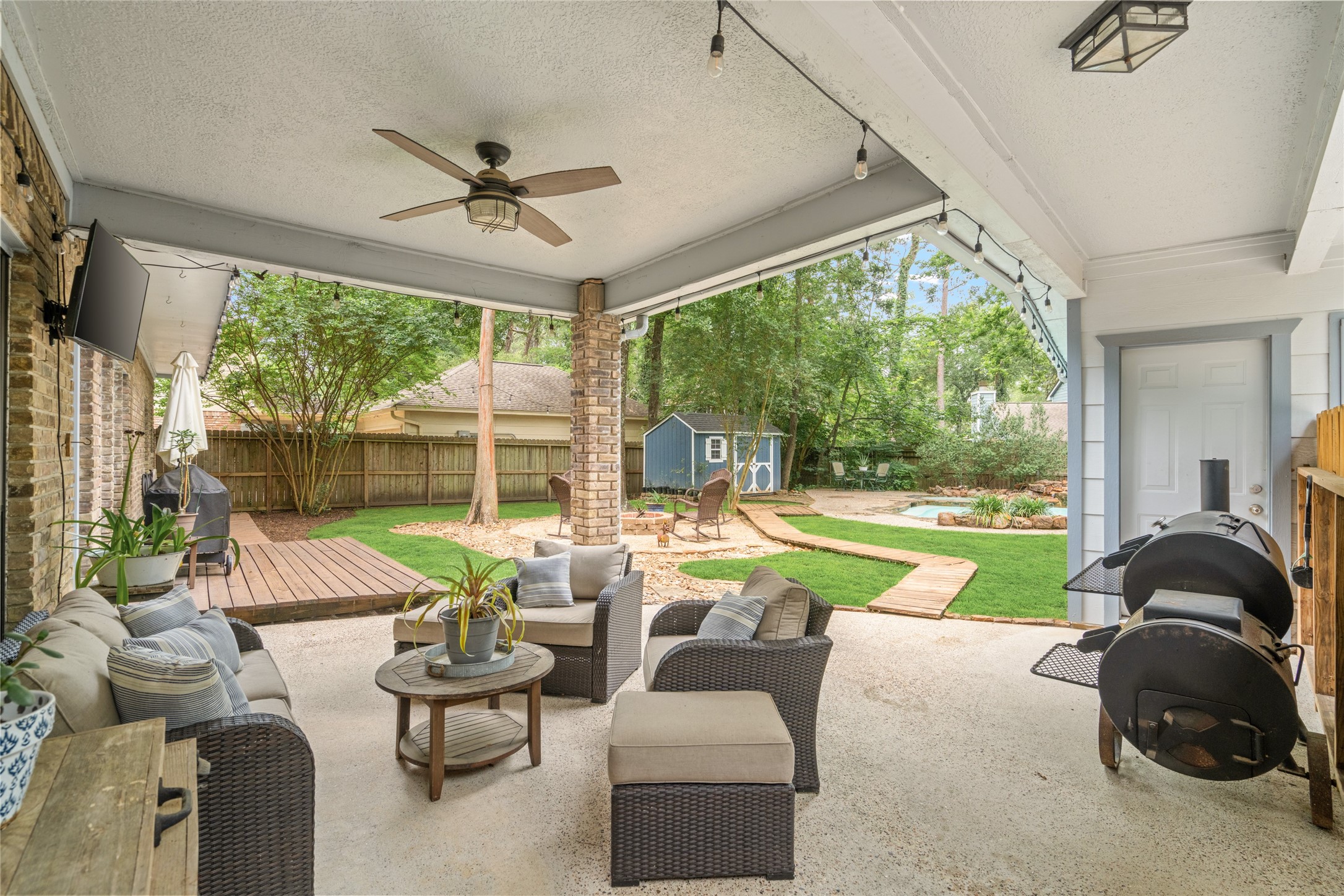 77 South Placid Hill Circle Spring, TX 77381 - Photo 37 of 48 Spacious covered patio overlooking the pool and private backyard with mature trees, outdoor lighting, and multiple entertaining areas.