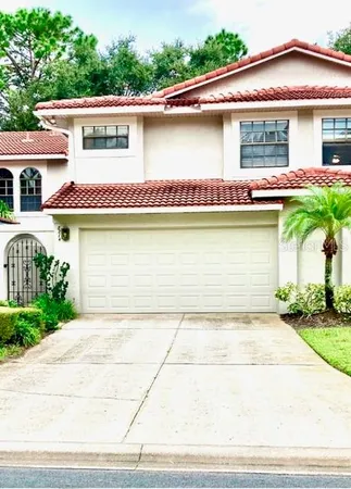 a front view of a house with a garden and plants