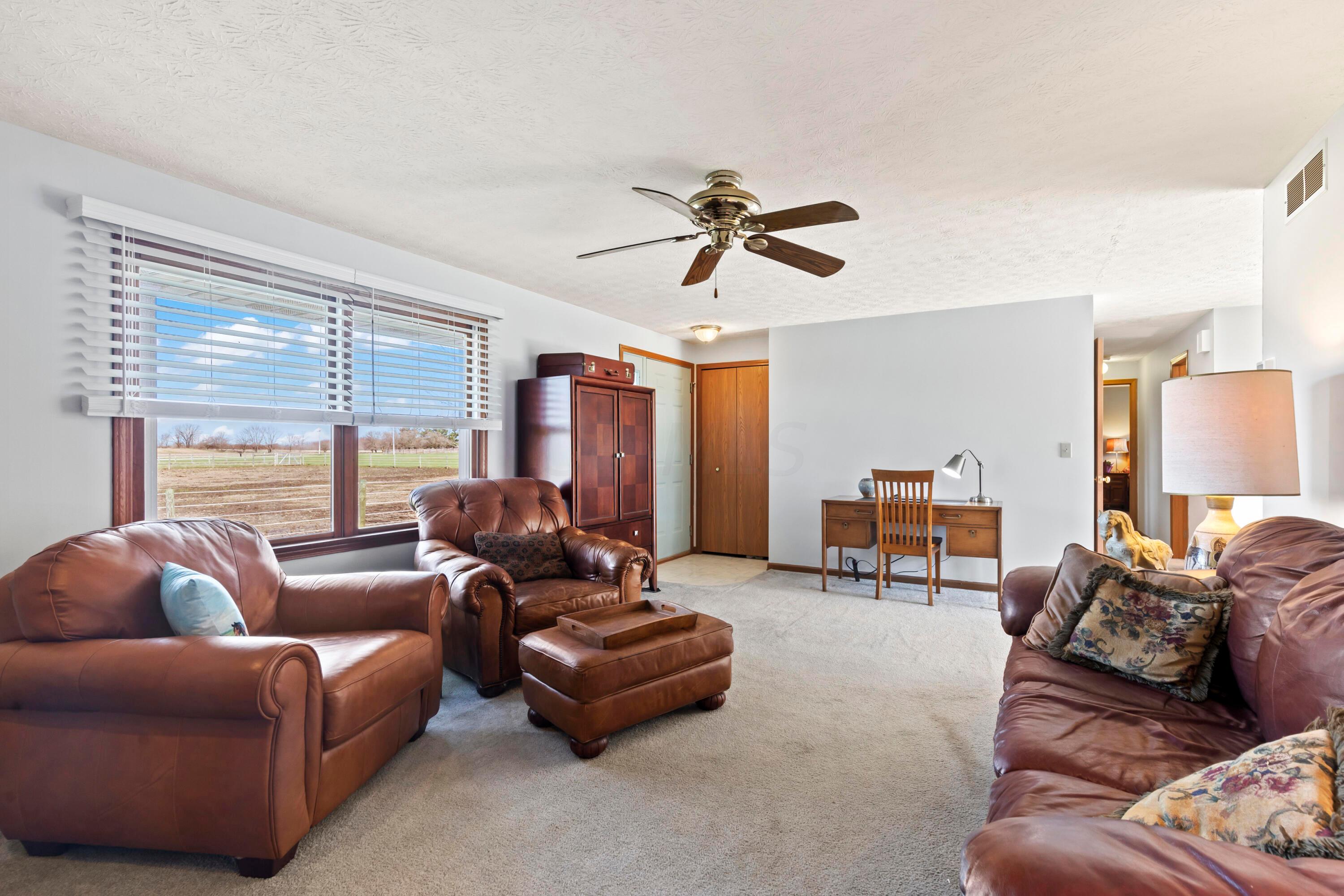 • Light sand carpet
• Ivory painted walls
• Woodburning brick fireplace
with mantle, heatilator & raised
hearth
• Can lighting
• Ceiling fan
• 2” blinds