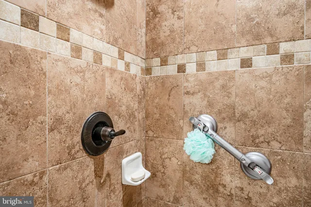 a bathroom with a granite countertop shower and a sink