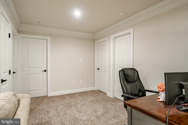 a living room with furniture and a ceiling fan
