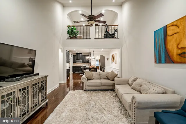 a view of a dining room with furniture a chandelier and wooden floor