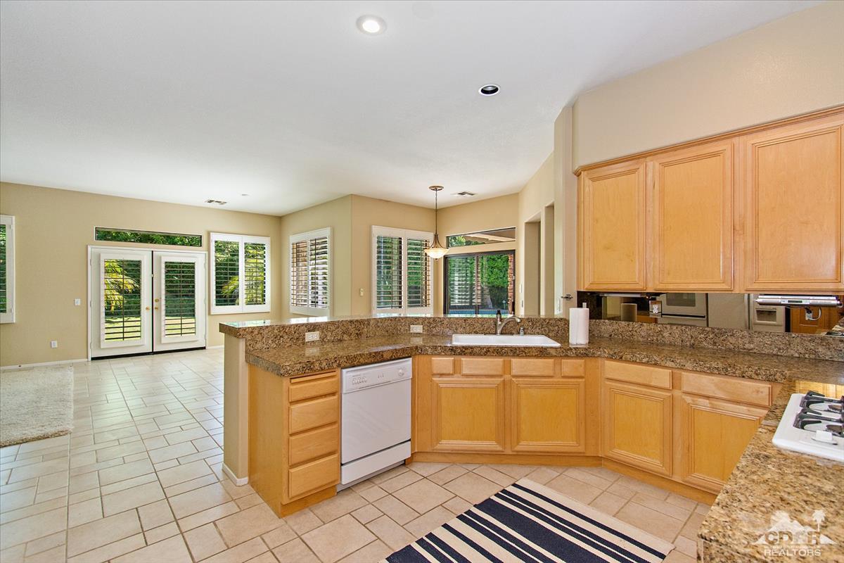 38 Santa Ynez Rancho Mirage, CA 92270 - Photo 2 of 38 a large kitchen with a window a sink and cabinets