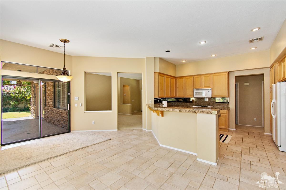 38 Santa Ynez Rancho Mirage, CA 92270 - Photo 11 of 38 a view of a kitchen with kitchen island granite countertop a refrigerator and a sink