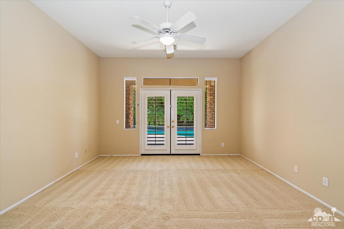 38 Santa Ynez Rancho Mirage, CA 92270 - Photo 22 of 38 an empty room with windows and ceiling fan