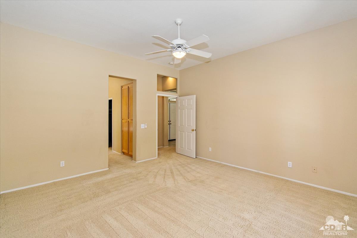 38 Santa Ynez Rancho Mirage, CA 92270 - Photo 24 of 38 an empty room with a ceiling fan and a window