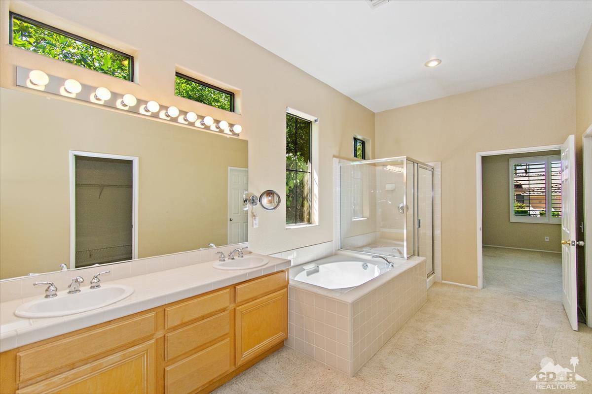 38 Santa Ynez Rancho Mirage, CA 92270 - Photo 26 of 38 a bathroom with a tub sink and mirror