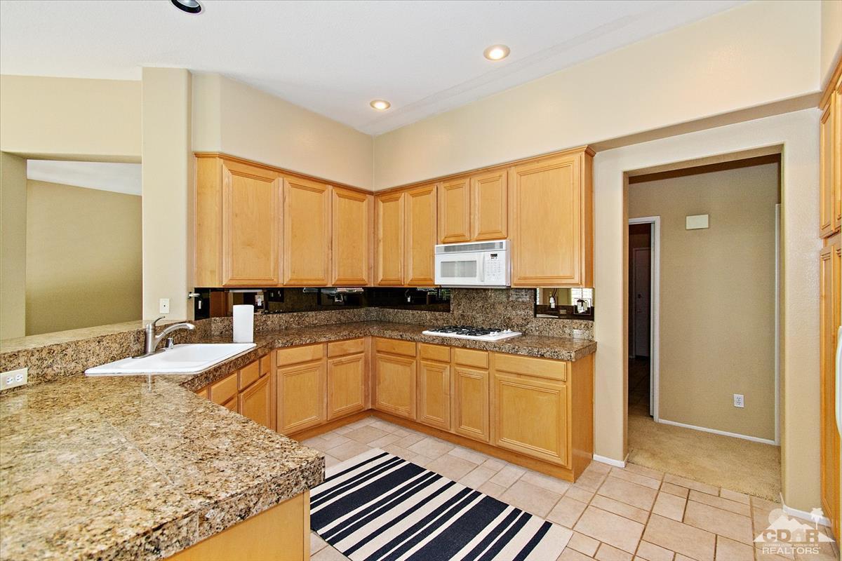 38 Santa Ynez Rancho Mirage, CA 92270 - Photo 5 of 38 a kitchen with stainless steel appliances granite countertop a sink and cabinets