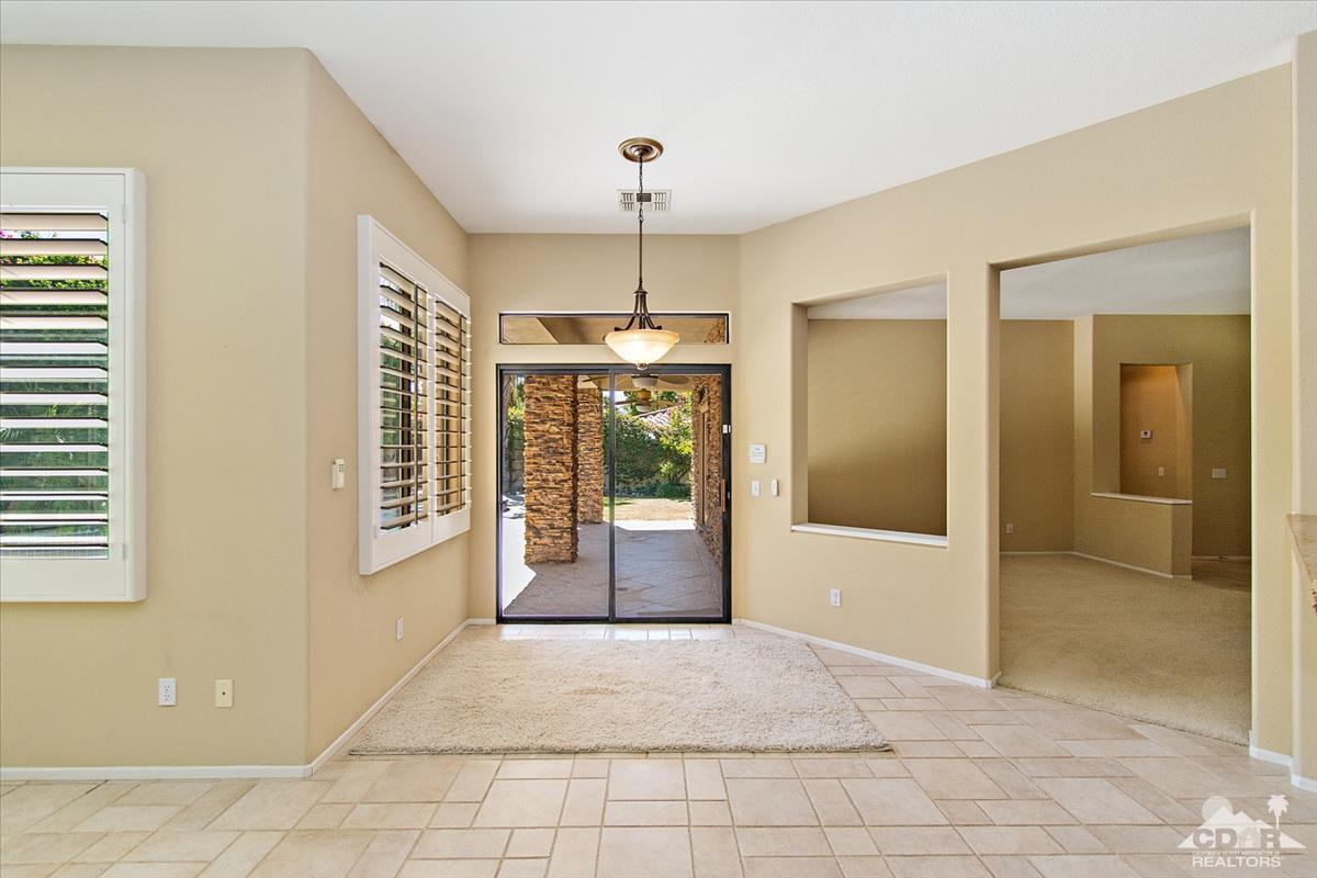 38 Santa Ynez Rancho Mirage, CA 92270 - Photo 6 of 38 a view of an entryway with wooden floor and a living room
