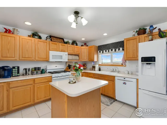 a kitchen with stainless steel appliances a sink a stove a refrigerator and cabinets