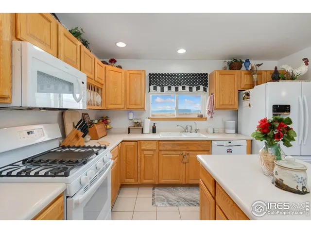 a kitchen with a sink a stove and cabinets