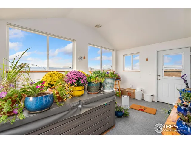 a bedroom with a bed next to a window with outer view