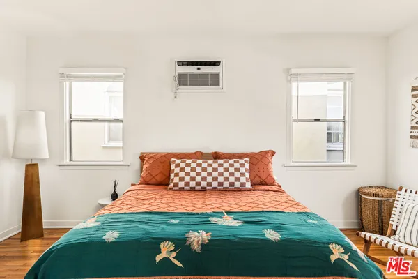 a bedroom with a large bed and a window