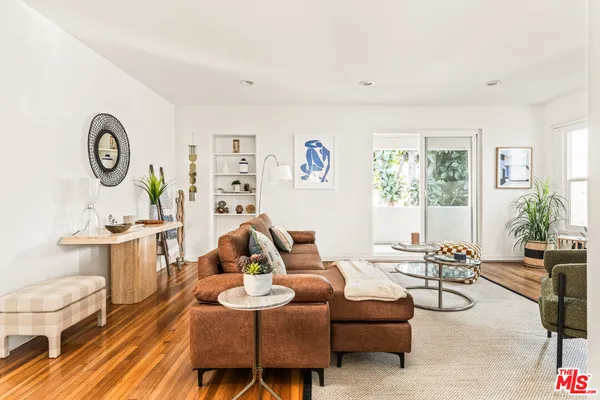 a living room with furniture a clock and a window