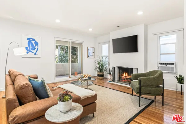 a living room with furniture fireplace and a flat screen tv