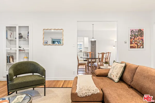 a living room with furniture and a painting