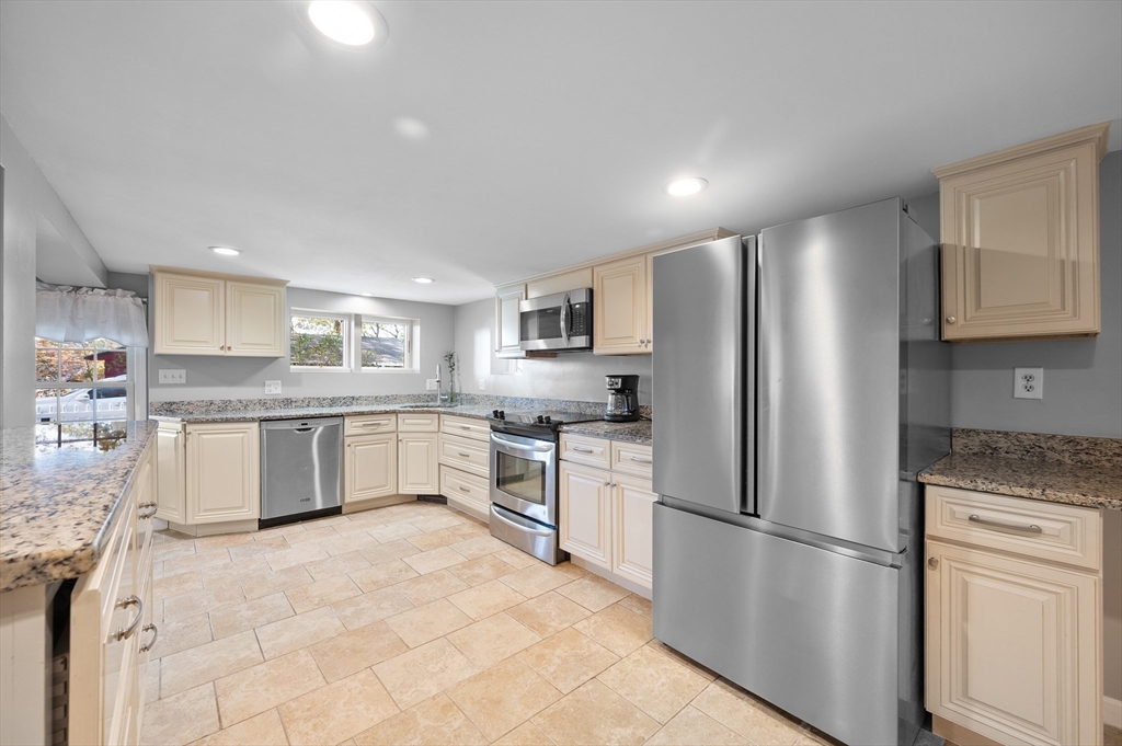 27 Downey Street Hopkinton, MA 01748 - Photo 5 of 36 a kitchen with stainless steel appliances granite countertop a refrigerator sink and white cabinets
