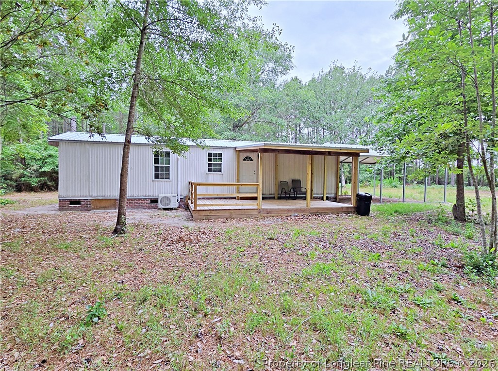 1031 Pine Acres Road White Oak, NC 28399 - Photo 25 of 29 a backyard of a house with garden and trees