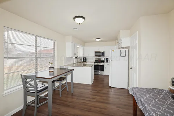 a kitchen with a table and chairs in it