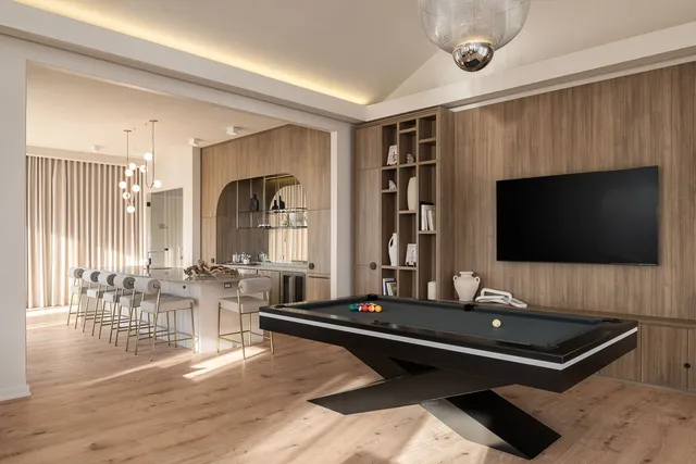 a living room with furniture flat screen tv and a large window