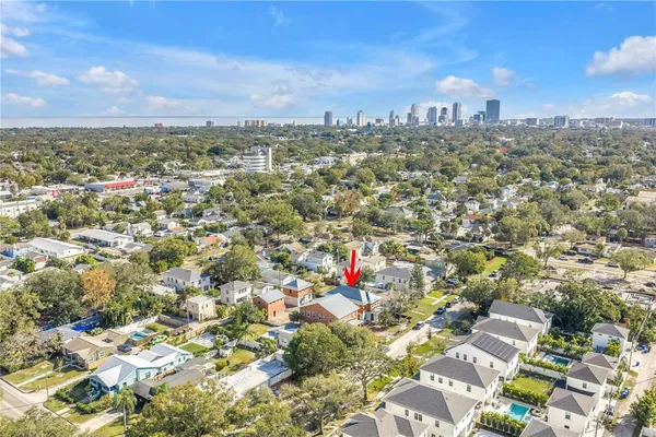 an aerial view of residential houses with city view