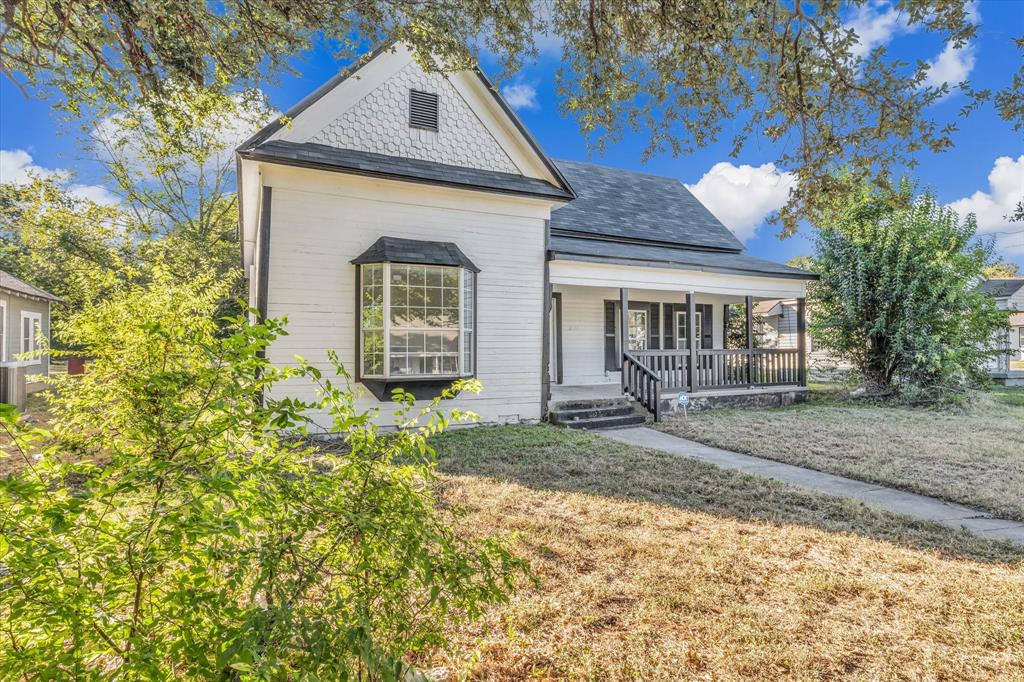 2524 McFerrin Avenue Waco, TX 76708 - Photo 3 of 29 View of front of house featuring a porch, a front lawn, and a shingled roof