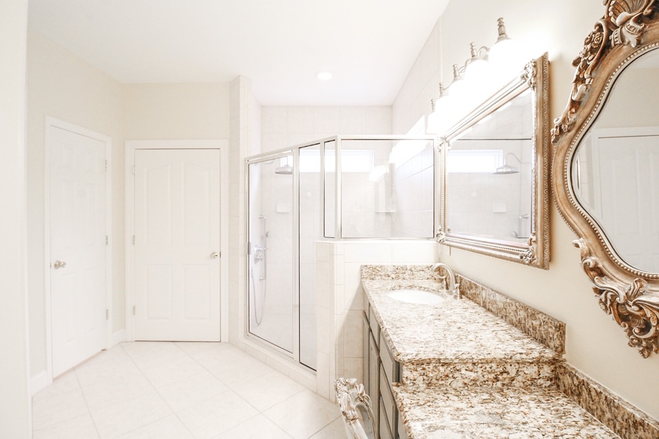 4840 Redcastle Ridge Nashville, TN 37211 - Photo 19 of 37 a bathroom with a granite countertop sink a mirror and a shower