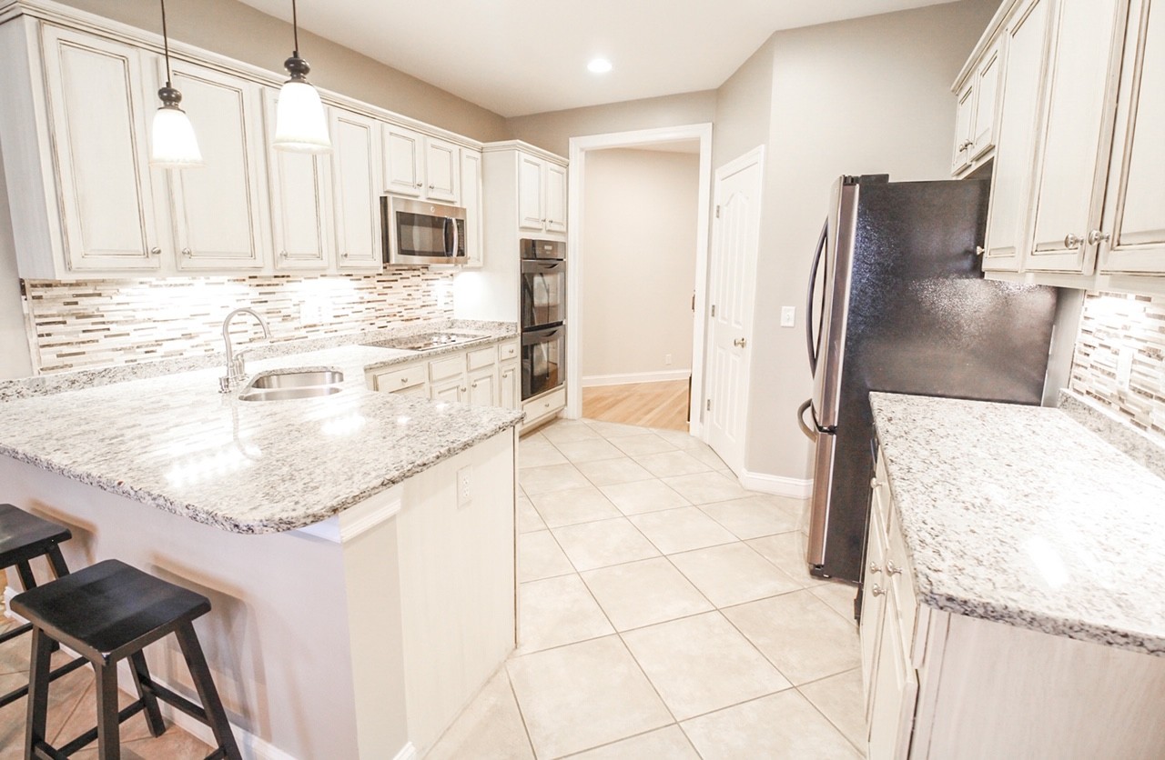 4840 Redcastle Ridge Nashville, TN 37211 - Photo 24 of 37 a bathroom with a granite countertop sink and a mirror