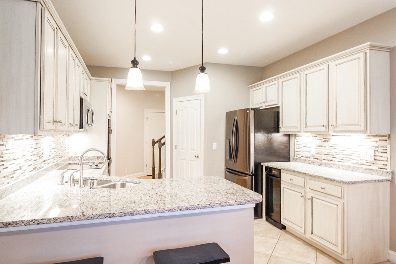 4840 Redcastle Ridge Nashville, TN 37211 - Photo 25 of 37 a kitchen with stainless steel appliances granite countertop a sink a refrigerator and a granite counter tops