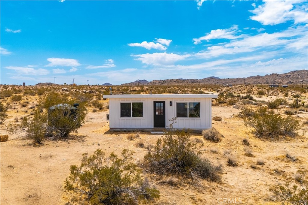777 Quail Bush Road Landers, CA 92285 - Photo 26 of 46 a view of a house with a yard
