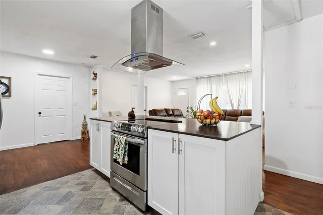 a kitchen with stainless steel appliances granite countertop a sink and a refrigerator