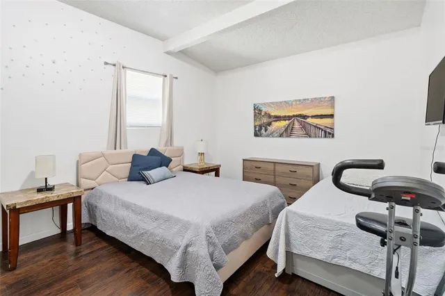 a bedroom with two beds and a desk