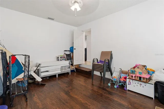a bedroom with furniture and a wooden floor