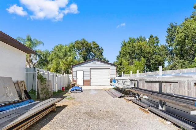 a view of a small house in the middle of a yard