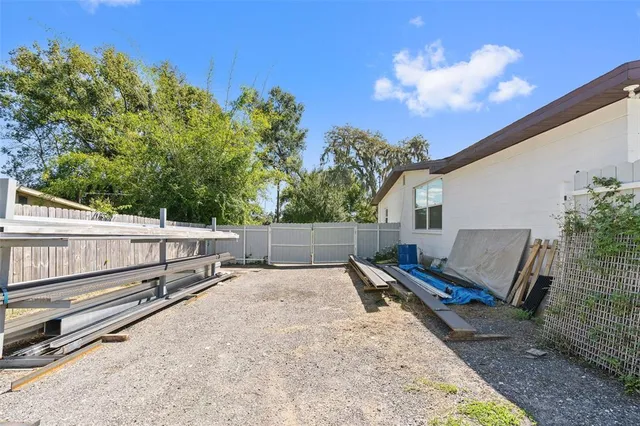 a view of a bench in back yard of a house