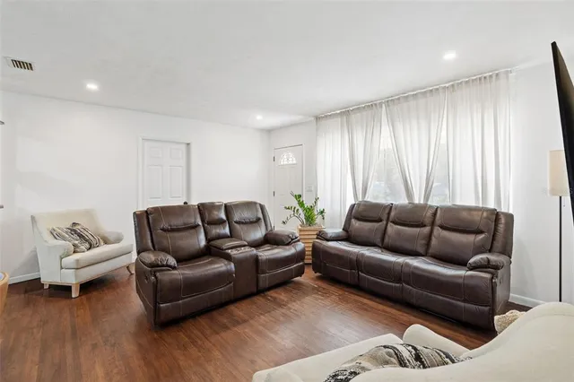 a living room with furniture window and wooden floor