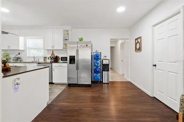 a kitchen with stainless steel appliances a refrigerator sink and cabinets